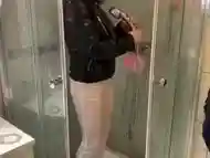 Amateur girl Leather jacket and white pants getting soaking wet in the shower