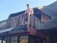 Bikini slut pissing from a balcony