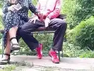 Hot MILF jerks off a big dick into a glass in the park on a bench