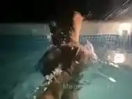 Lesbian couple playing in the pool on vacation