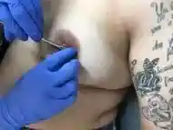 Nice pair of nipples getting pierced