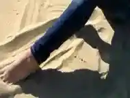 Red Toe Nails in the Beach Sand