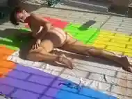 Touch pussy outdoors. Attractive lady is sunbathing on the roof of hotel