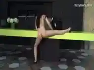 Young gymnast with beautiful breast performing splits, bridge and more..