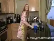 Blonde mature Heidi washes the dishes