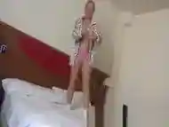 Submissive blonde wife skipping rope on the bed