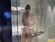 Smalltitted tranny showering while filmed