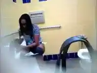 Bootylicious black MILF pees in a restroom