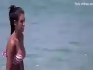 Brunette at the beach filmed as she provides pure beauty