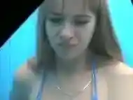 Cute teen putting on a blue bikini