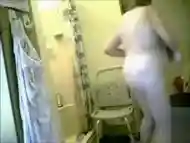 Granny dries her body after a shower