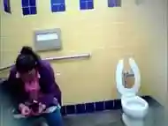 Mature Mexican woman goes pee in a public bathroom