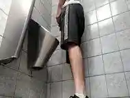 A busy guy with an uncut dick peeing in a public toilet