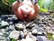 Fat Hippie redhead masturbating by a creek naked PUBLIC velma voodoo