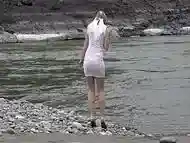 Juicy ass and slender legs under a short narrow dress outdoors in a public place. Russian beauty exposes her intimate places while walking along the riverbank.