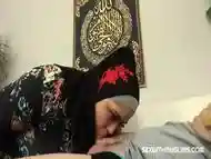 A busty woman in a hijab got a really hard gift