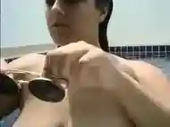 Beautiful girl shows her charms in the pool