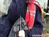 Cute Japanese chick has vibrator pleasing her in the rain