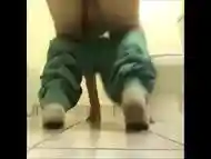 Girl shitting on the floor of the toilet