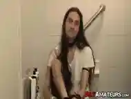 Long haired stud working on his cock on the bathtub